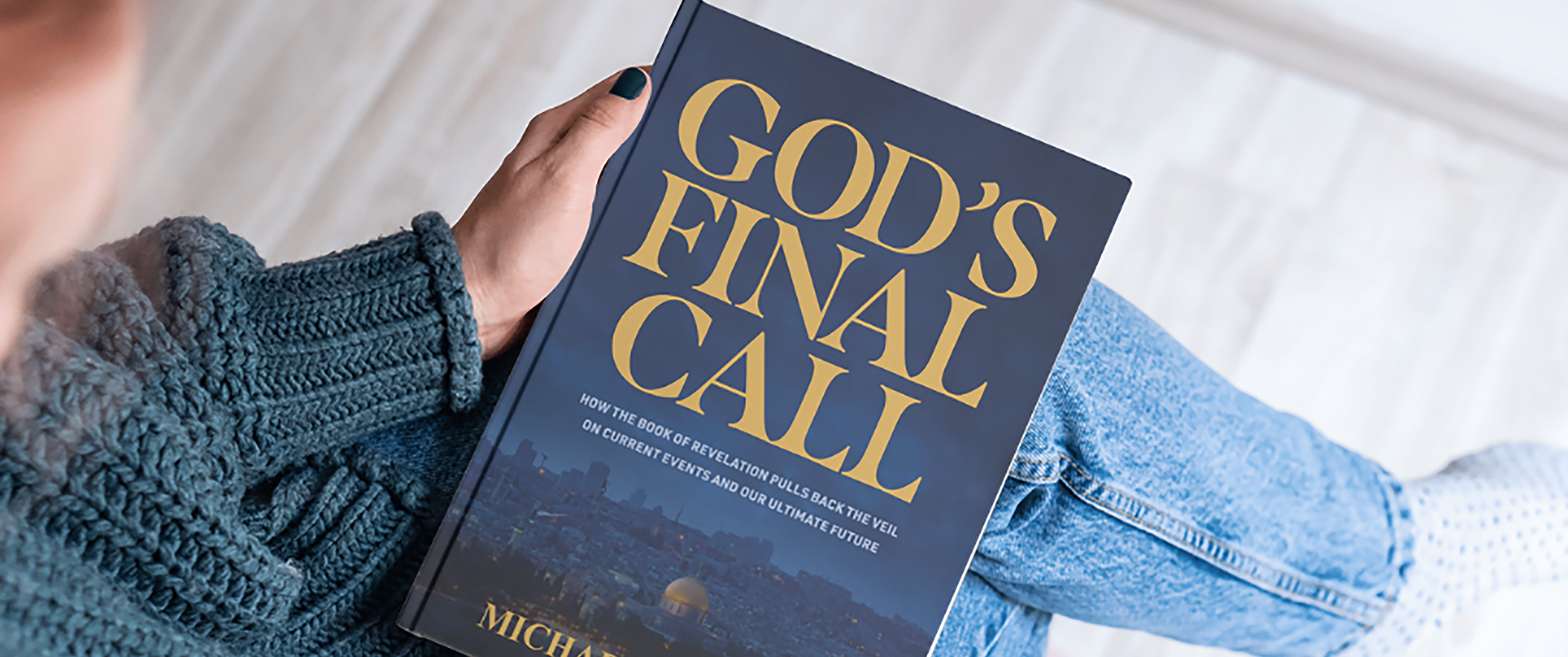 Woman holding God’s Final Call by Dr. Michael Youssef, a powerful book on Biblical Truth and the urgency of the Gospel